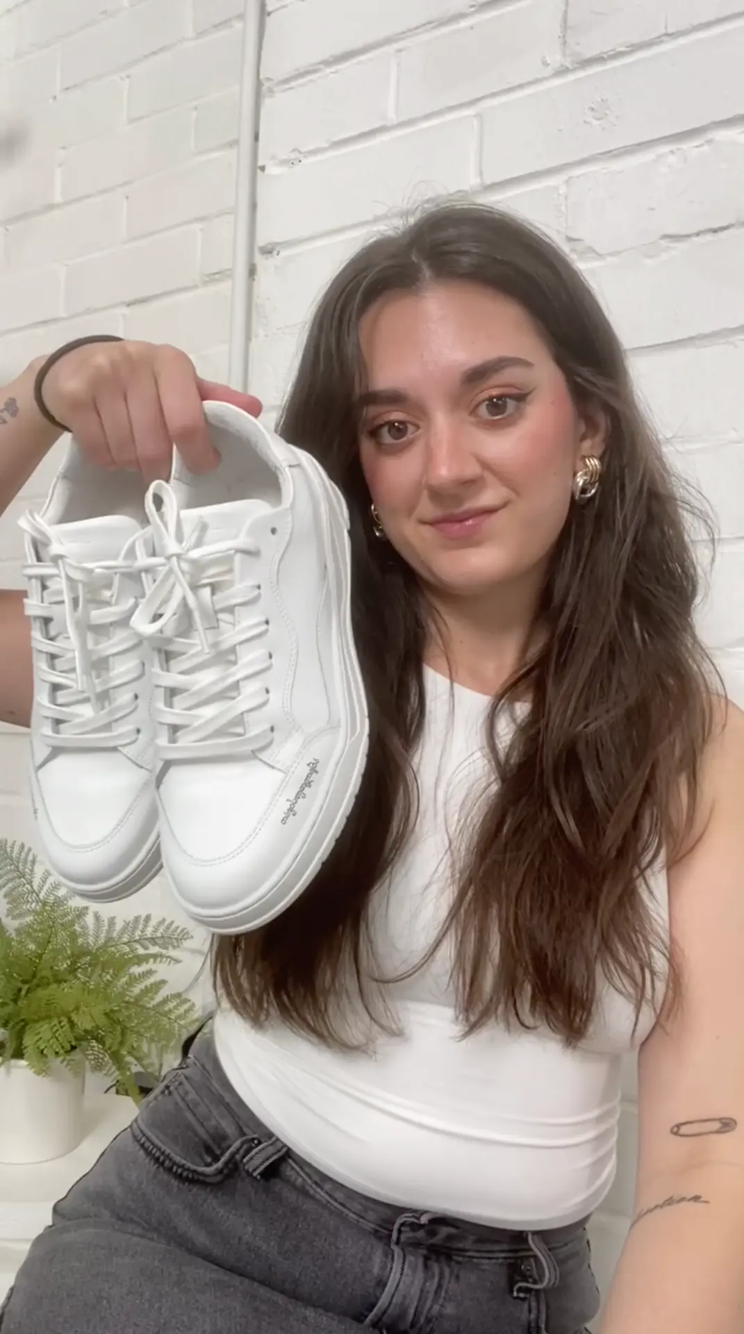 Creator unboxing white sneakers in a UGC video